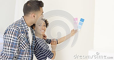 Young couple choosing a paint color Stock Photo