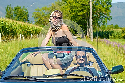 A young couple in a convertible car Stock Photo