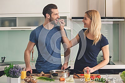 Young couple cooking together meal preparation indoor Stock Photo