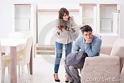 The young couple disappointed with price in furniture store Stock Photo