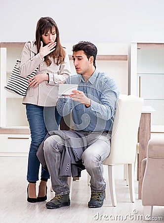 Young couple disappointed with price in furniture store Stock Photo