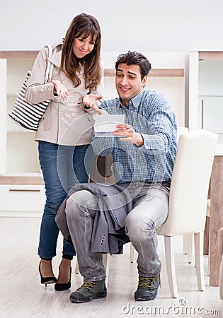 Young couple disappointed with price in furniture store Stock Photo