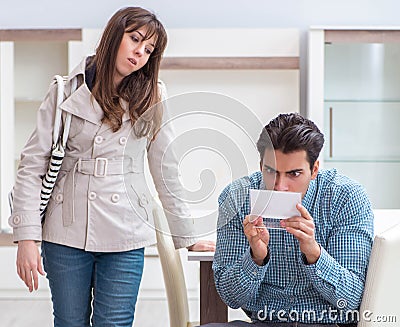 Young couple disappointed with price in furniture store Stock Photo