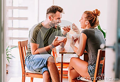 Young couple eating cereal breakfast Stock Photo