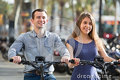 Young couple with electric bikes Stock Photo