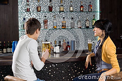 Young couple enjoying a beer at the bar Stock Photo
