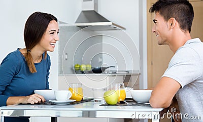Young Couple Enjoying Breakfast in the kitchen Stock Photo