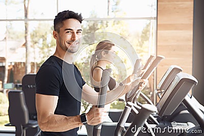 Young couple exercise together in gym healthy lifestyle Stock Photo