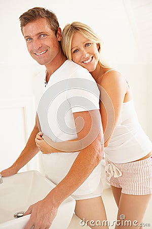 Young Couple Getting Ready In Bathroom Stock Photo