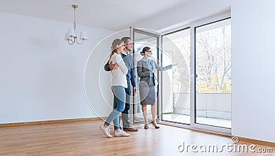 Young couple getting tour through apartment they consider renting Stock Photo