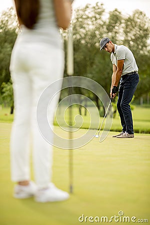 Young couple at golf court Stock Photo