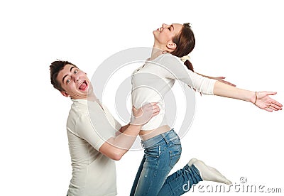 Young couple, guy with jumping up girl, studio, isolated Stock Photo