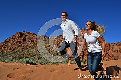 Young Couple Happily Running Together Stock Photo