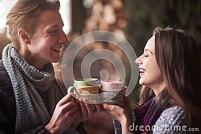 Young couple having breakfast in a romantic cabin outdoors in winter. Winter holiday and vacation. Christmas couple of Stock Photo