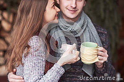 Young couple having breakfast in a romantic cabin outdoors in winter. Winter holiday and vacation. Christmas couple of Stock Photo