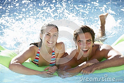 Young Couple Having Fun With Inflatable Airbed Swimming Pool Together Stock Photo