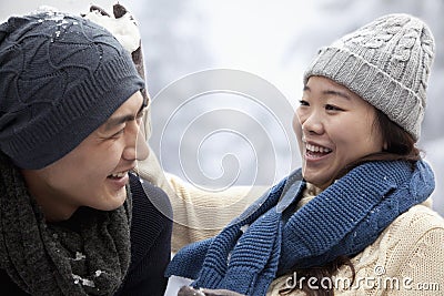 Young Couple Having a Snowball Fight Stock Photo