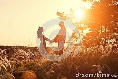 Young couple holding hands. In nature sunrise Stock Photo