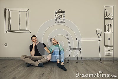 Couple imagine interior of new house. sitting on floor and thinking in empty room Stock Photo