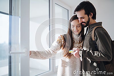 Young couple with keys moving in new flat, new home and relocation concept. Stock Photo