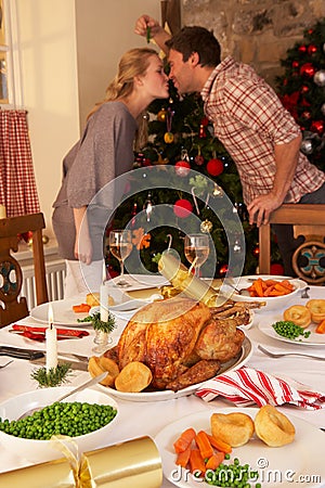 Young couple kissing under mistletoe at Christmas Stock Photo