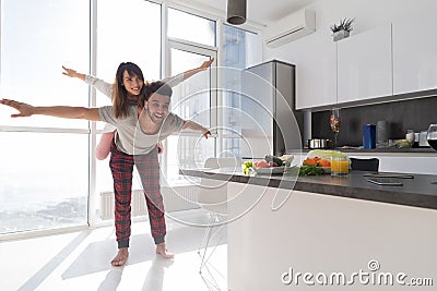 Young Couple In Kitchen, Lovers Hispanic Man Carry Asian Woman Modern Apartment Stock Photo