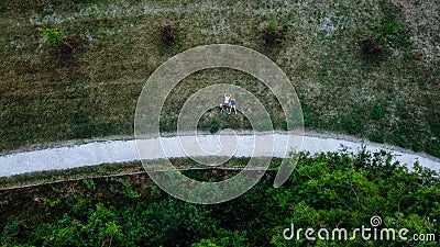 Young couple laying on the grass, drone photo, aerial perspective, bird`s eye view Stock Photo