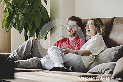 Couple watching TV on a sofa at home Stock Photo
