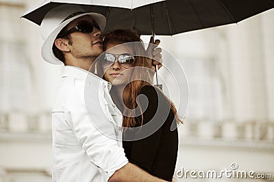 Young fashion couple in love with umbrella Stock Photo
