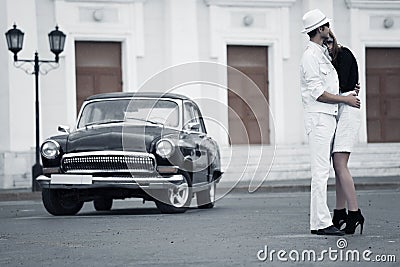 Young fashion couple in love at the retro car Stock Photo