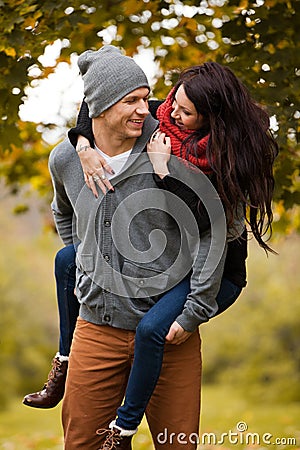 Young couple in love frolicking in a park Stock Photo