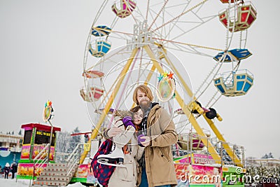 Young couple in love with a happy young man with a beard and a woman on a background of a colossus, a Ferris wheel resting Editorial Stock Photo