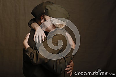 Young couple in love in military uniform from second world war hugs from joyous long awaited meeting Stock Photo