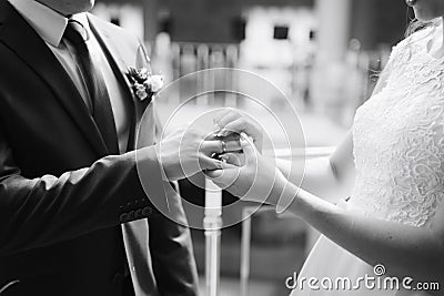 Young couple in love newlyweds exchange gold wedding rings 1 Stock Photo