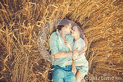 Young couple in love outdoor.Couple hugging.Young beautiful couple in love staying and kissing on the field on sunset. Stock Photo