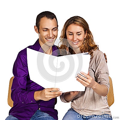 Young couple in love reading together a brochure Stock Photo