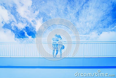 Young couple in love takes selfie portrait on the bridge. Blue toned Stock Photo