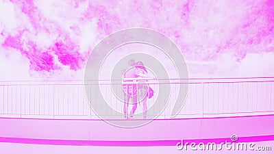 Young couple in love takes selfie portrait on the bridge. Pink fuchsia toned. 16:9 panoramic format, copy space Stock Photo