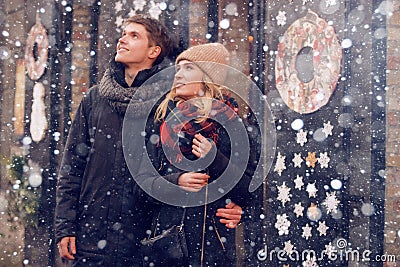 Young couple in love couple travels on St. Valentine`s Day. Holidays in Europe. Warm clothes, hat. scarf, nice atmosphere. Winter, Stock Photo