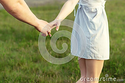 Young couple in love walking in the autumn park holding hands looking in the sunset Stock Photo