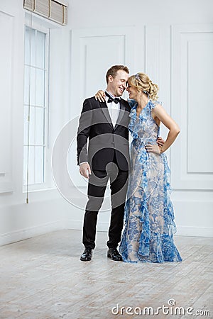 Young couple in luxury fashionable clothes laughing indoors Stock Photo