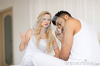 Young Couple Lying In Bed, Having Conflict Relationships Problem, Sad Negative Emotions Unhappy Hispanic Man And Woman Stock Photo