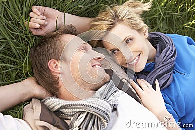 Young couple lying together on grass Stock Photo