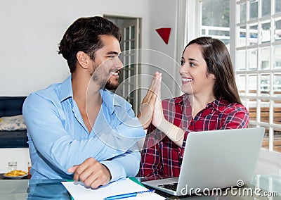 Young couple making online reservation with laptop Stock Photo