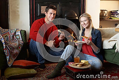 Young couple making toast on open fire Stock Photo