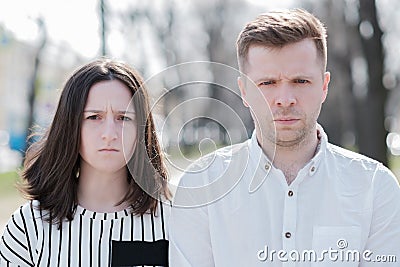 Young couple man and woman looking irritated in camera Stock Photo