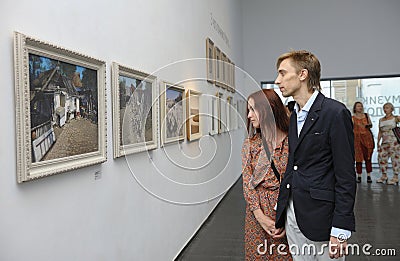 Young couple man woman visitors looking at the painting of famous Ukrainian painter Ivan Marchuk during opening his Editorial Stock Photo