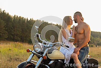 Young couple on a motorcycle in the field Stock Photo