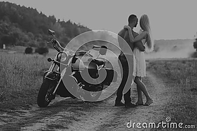 Young couple on a motorcycle in the field Stock Photo