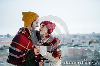 Young couple owners with coffee on balcony in new flat, moving in, new home and relocation concept. Stock Photo